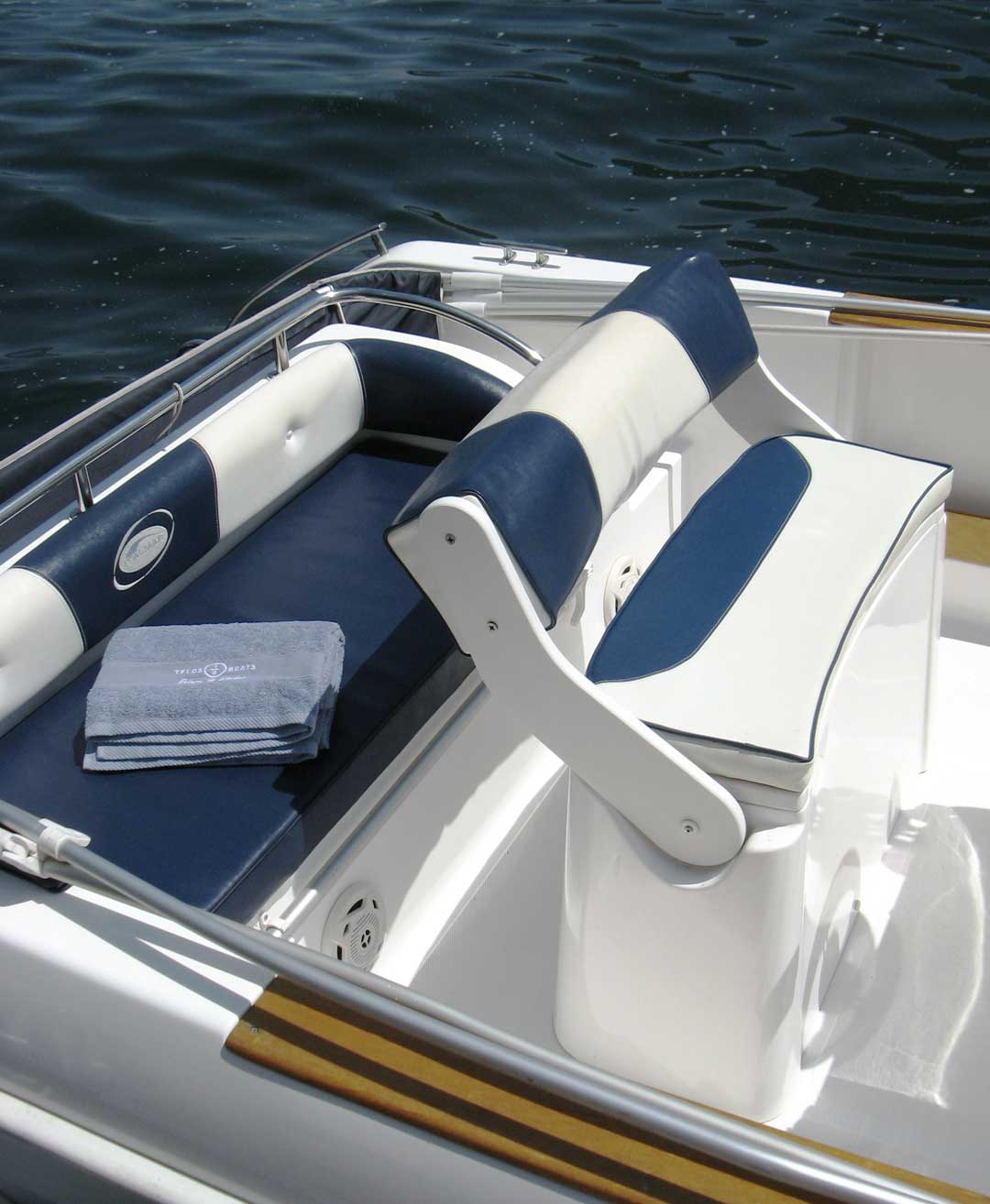 Comfortable helm station and rear seating area aboard a Telos Boats self-drive boat.